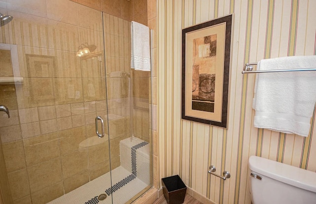 bathroom featuring an enclosed shower and toilet