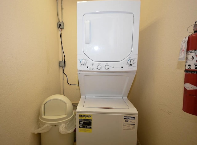 laundry room with stacked washer / dryer