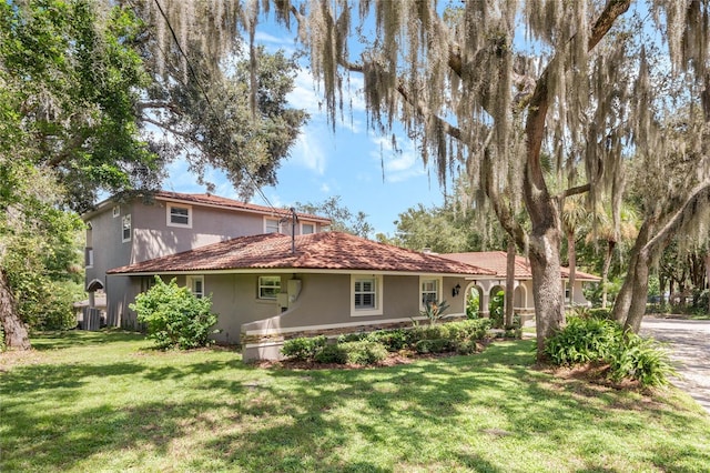 exterior space with a front lawn and central air condition unit