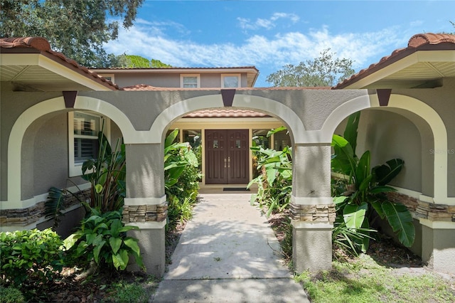 view of exterior entry with a porch