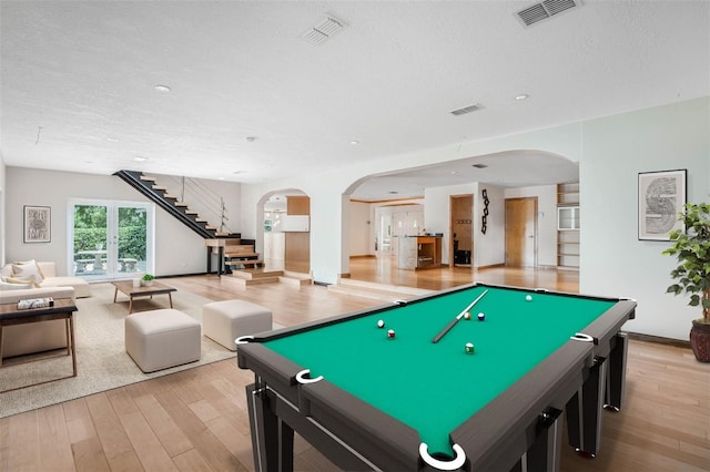 playroom featuring pool table, a textured ceiling, and light hardwood / wood-style floors