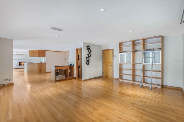 unfurnished living room with light hardwood / wood-style floors