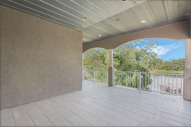 view of patio / terrace featuring a balcony and a water view