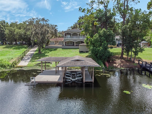 view of dock featuring a water view and a yard