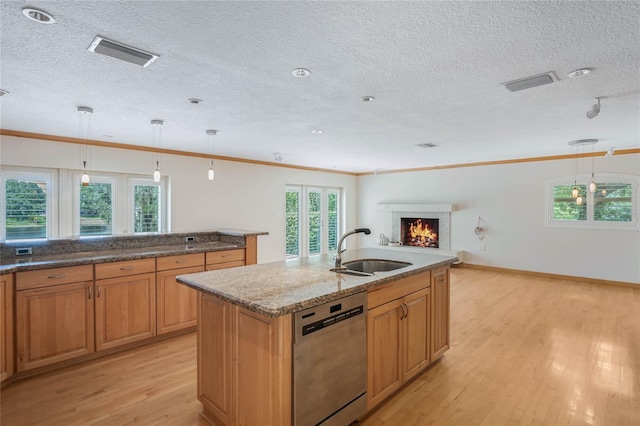 kitchen with pendant lighting, a kitchen island with sink, light hardwood / wood-style floors, and stainless steel dishwasher