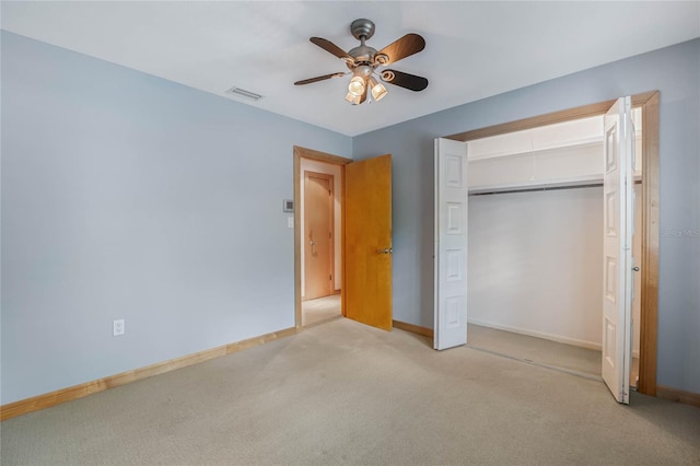 unfurnished bedroom featuring a closet, ceiling fan, and light colored carpet