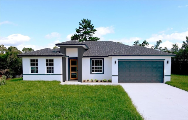 view of front of home with a garage and a front lawn