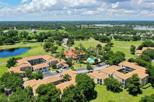 drone / aerial view featuring view of golf course and a water view