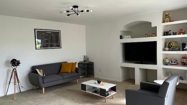 carpeted living room featuring built in shelves