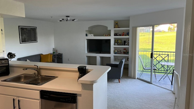 kitchen with sink, kitchen peninsula, white cabinetry, dishwasher, and light colored carpet