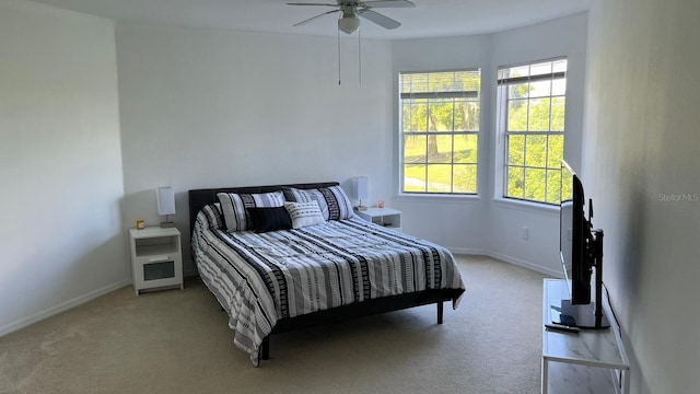 bedroom with ceiling fan and light colored carpet