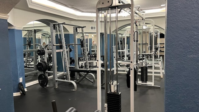 workout area with a textured ceiling and crown molding