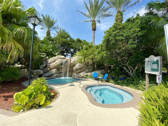 view of pool with pool water feature