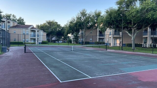 view of sport court featuring a residential view and fence