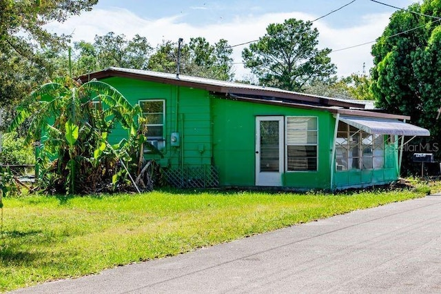 view of side of home with a yard