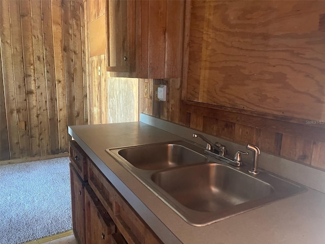 kitchen with wood walls and sink