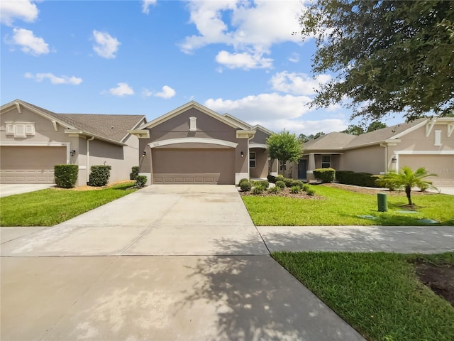 single story home with a front yard, concrete driveway, stucco siding, and an attached garage