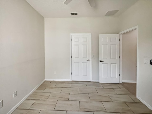 unfurnished bedroom featuring visible vents and baseboards