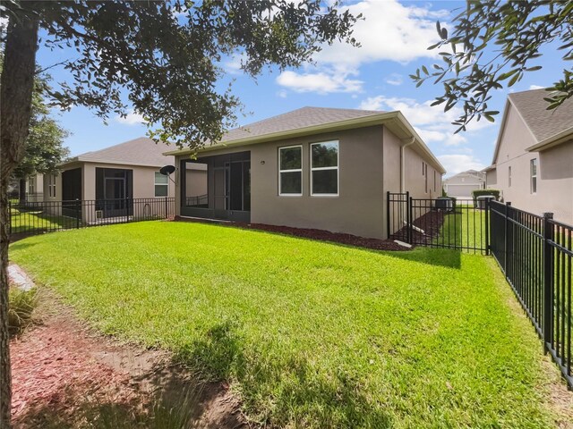 rear view of property featuring a yard