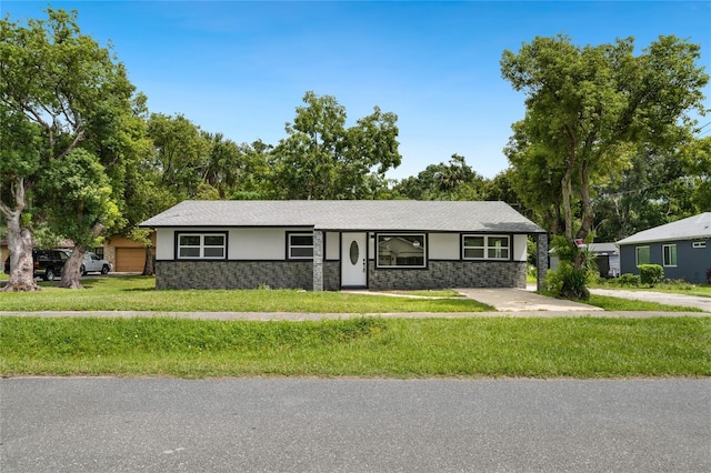 single story home with stucco siding, stone siding, and a front yard