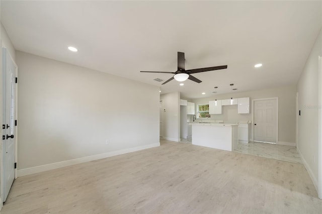 unfurnished living room featuring light wood-type flooring, visible vents, recessed lighting, baseboards, and ceiling fan