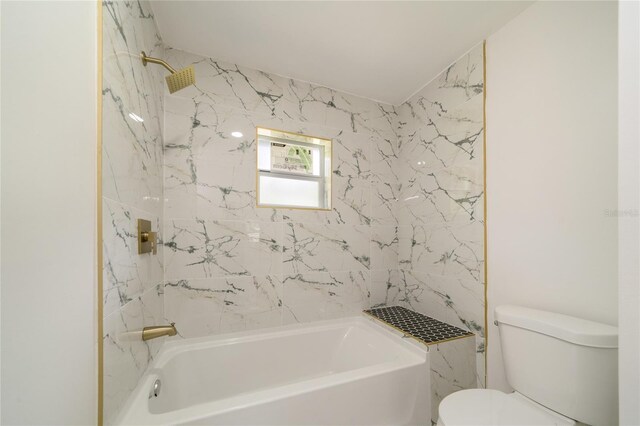 bathroom featuring toilet and tiled shower / bath combo