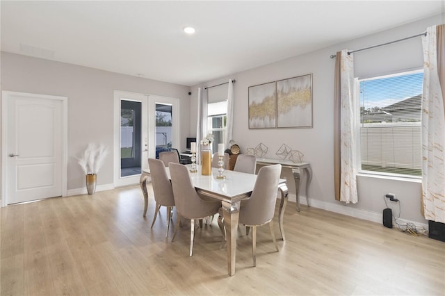 dining area featuring french doors and light hardwood / wood-style flooring