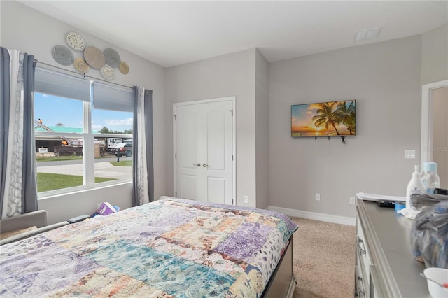 carpeted bedroom featuring a closet