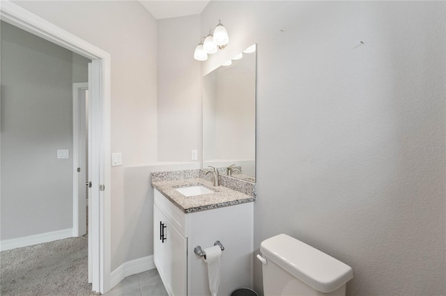 bathroom featuring vanity, toilet, and tile patterned floors