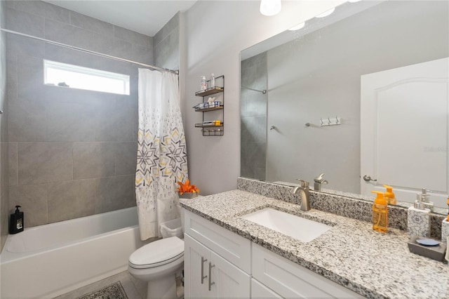 full bathroom featuring vanity, toilet, and shower / tub combo