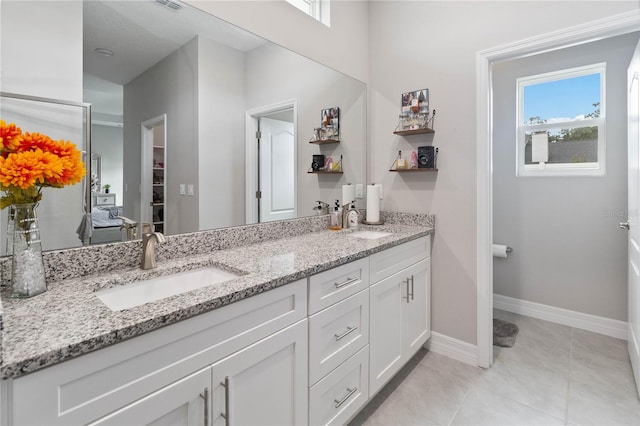 bathroom featuring tile patterned flooring and vanity