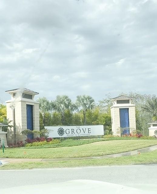 community / neighborhood sign with a yard