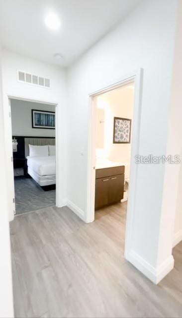 corridor with light hardwood / wood-style flooring