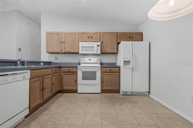 kitchen with light tile patterned floors, white appliances, sink, lofted ceiling, and a textured ceiling