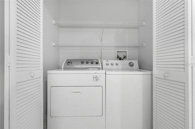 washroom with washing machine and clothes dryer