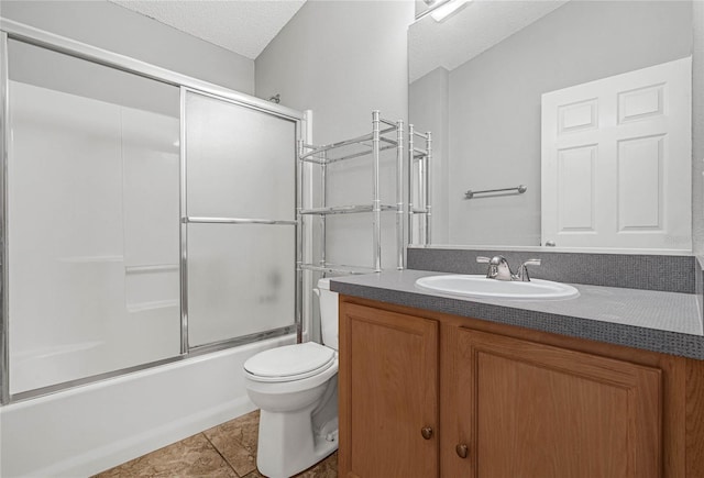 full bathroom with a textured ceiling, vanity, toilet, tile patterned floors, and enclosed tub / shower combo