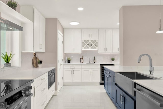 kitchen featuring decorative light fixtures, light stone countertops, decorative backsplash, appliances with stainless steel finishes, and white cabinets