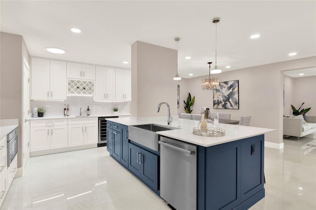 kitchen with a chandelier, dishwasher, sink, a center island with sink, and white cabinets