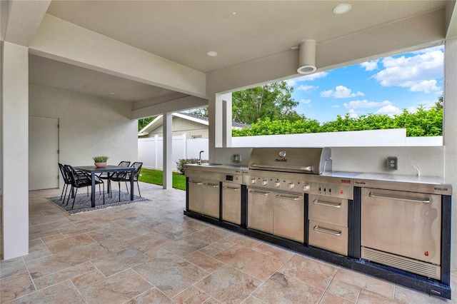 view of patio featuring an outdoor kitchen and sink