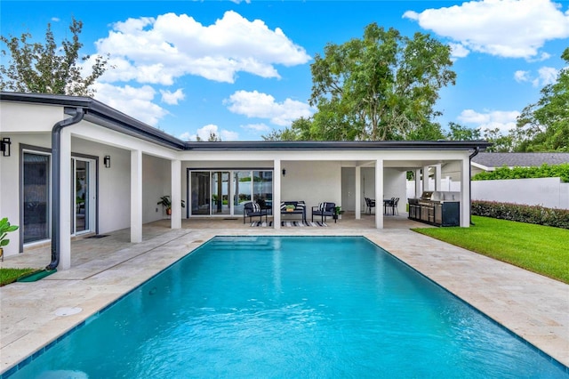 view of swimming pool featuring area for grilling and a patio