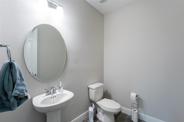 bathroom featuring tile patterned floors, toilet, and sink