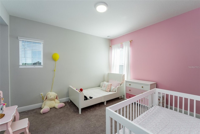 bedroom with carpet and a crib