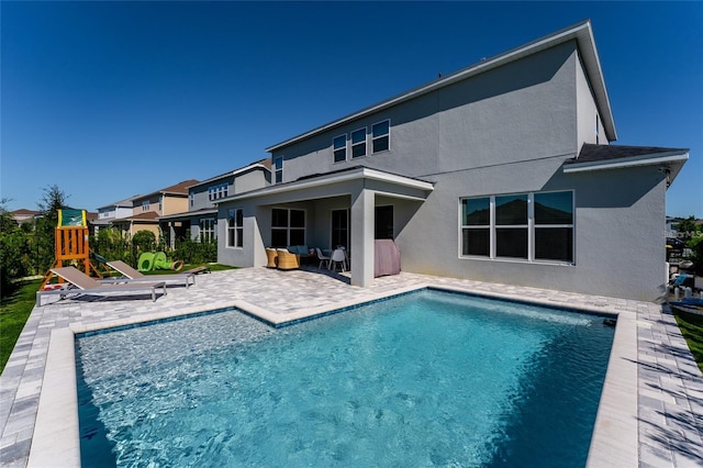 view of pool featuring a playground, a patio area, and an outdoor hangout area