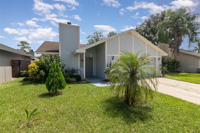 view of front facade with a front yard and a garage