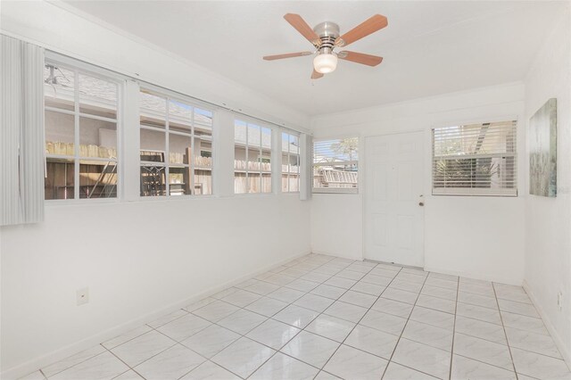 tiled spare room with ceiling fan