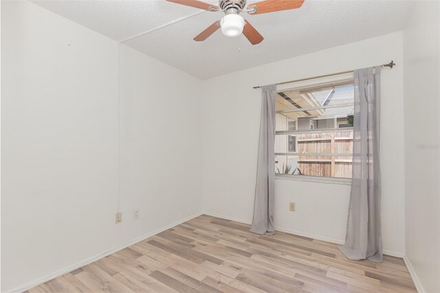 empty room featuring light wood-type flooring, a textured ceiling, and ceiling fan