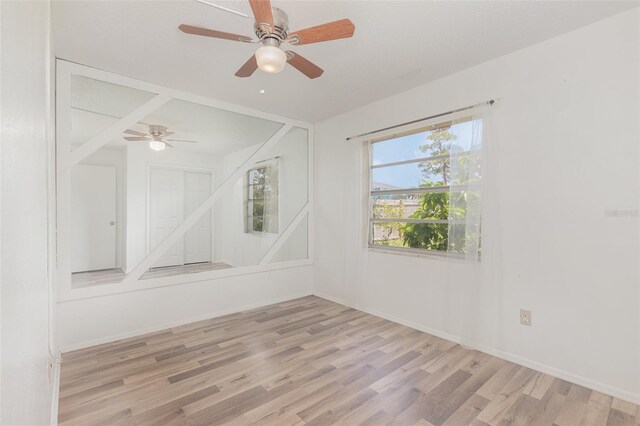 empty room featuring ceiling fan and light hardwood / wood-style floors