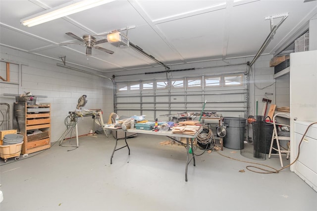 garage with a garage door opener and ceiling fan