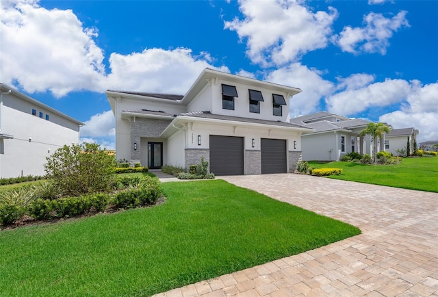 view of front facade featuring a front lawn and a garage