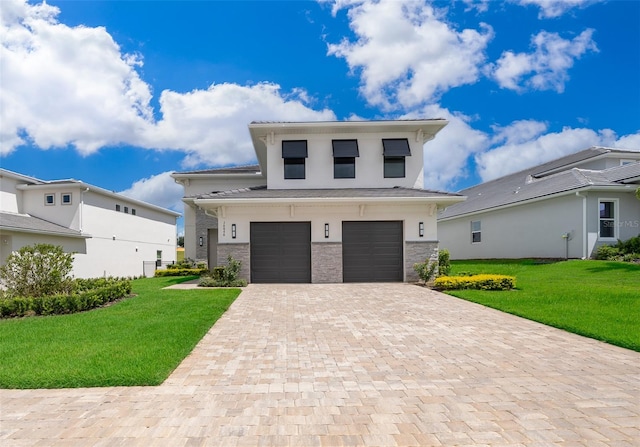 view of front of home featuring a front yard and a garage